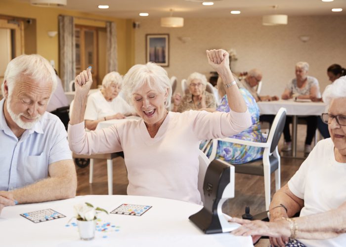 senior-woman-winning-game-of-bingo-in-retirement-h-2021-08-26-16-15-16-utc-scaled.jpg